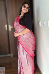 Woman wearing a Lavender Pure Tissue Cotton Saree with Rich Red Border with a black blouse indoors.