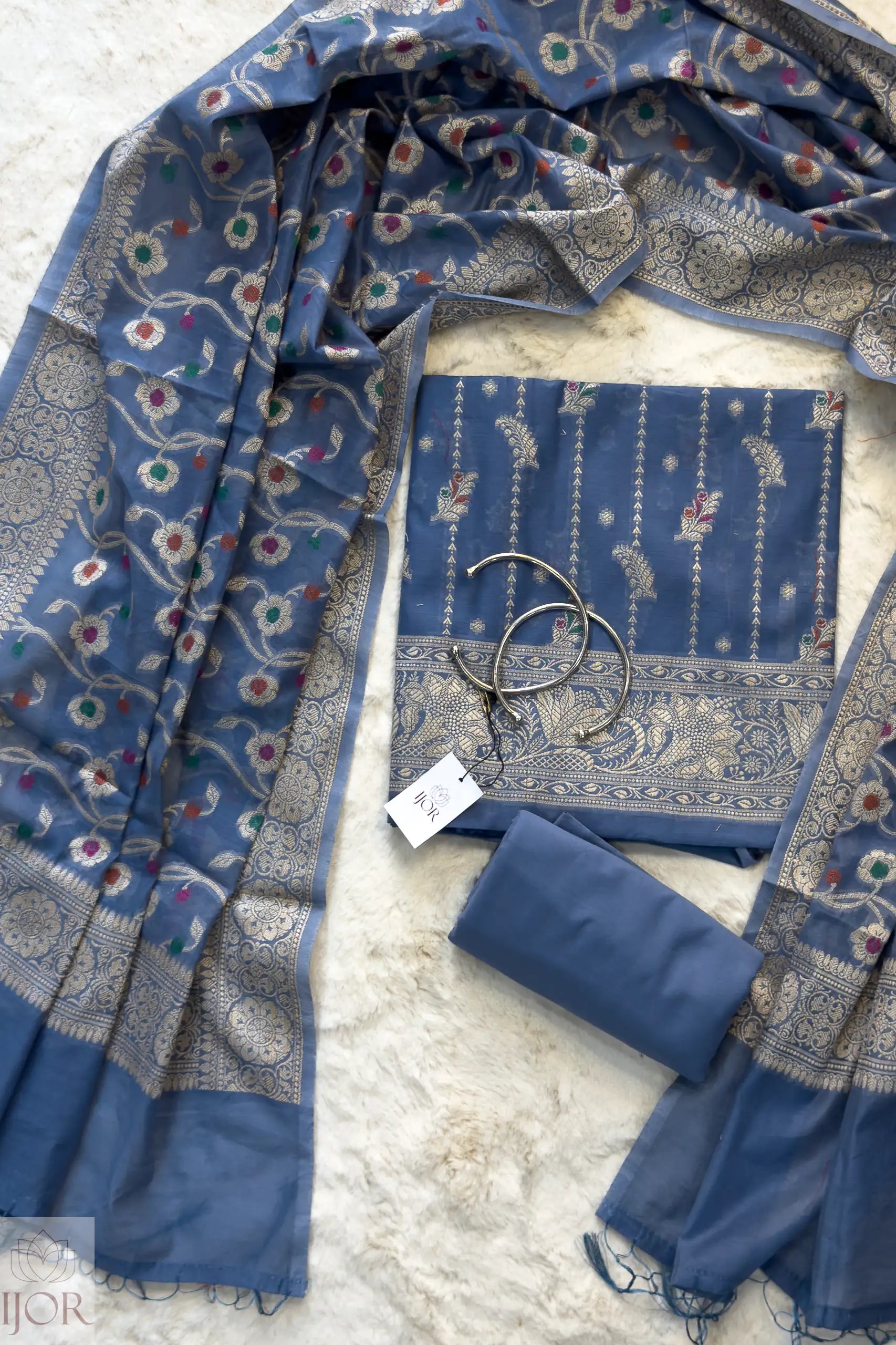 Dusty Blue Muga Silk in Minakari work Unstitched Suit on a light gray surface