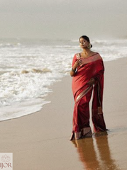 Divya Darshini ft. in Banarasi Soft Semi Katan Silk Saree Red standing on a beach with waves in the background