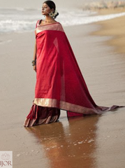 Divya Darshini ft. in Banarasi Soft Semi Katan Silk Saree Red standing on a beach with 'Jior' branding.