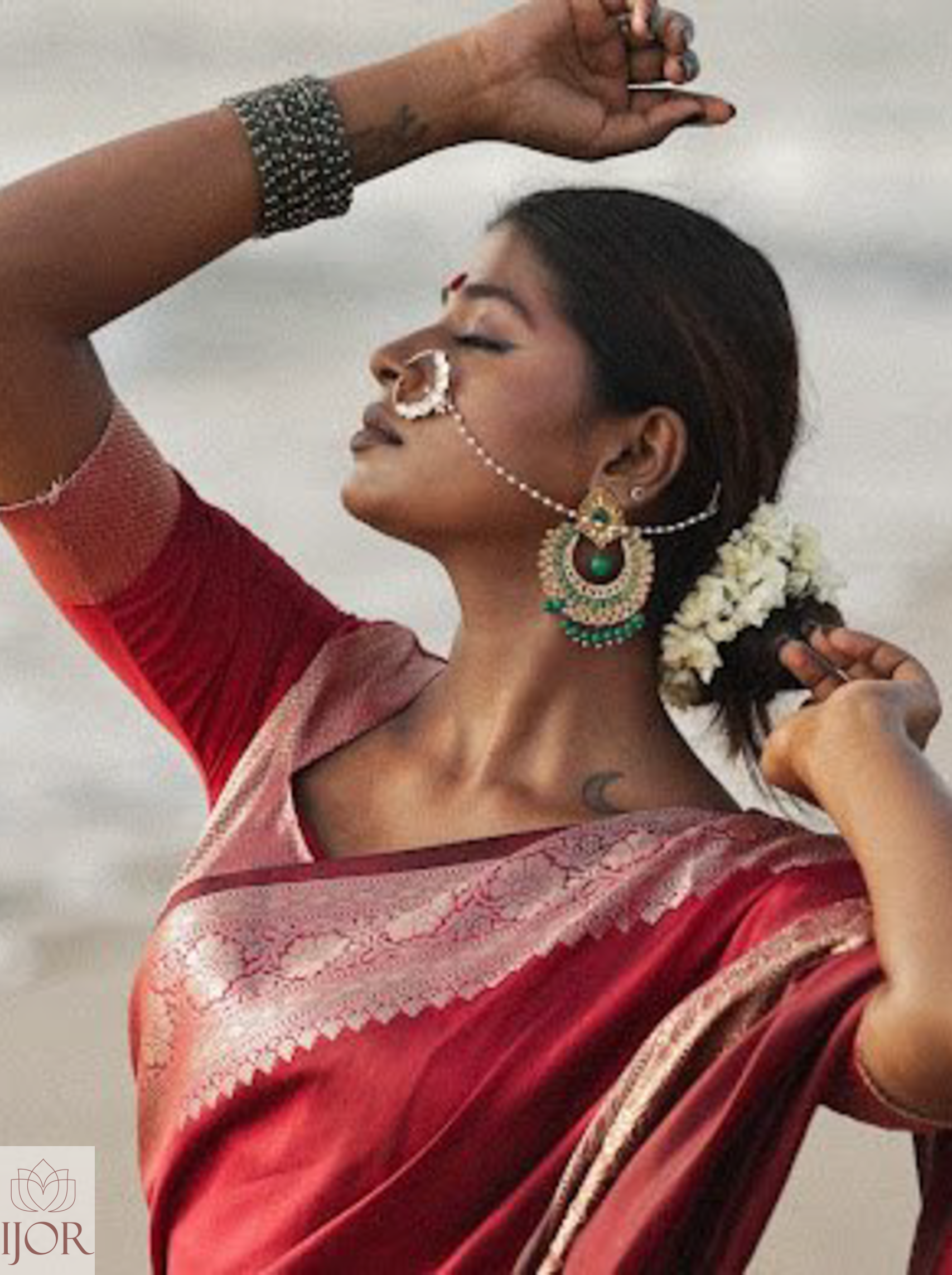 Divya Darshini ft. in Banarasi Soft Semi Katan Silk Saree Red with jewelry and flowers against a neutral background