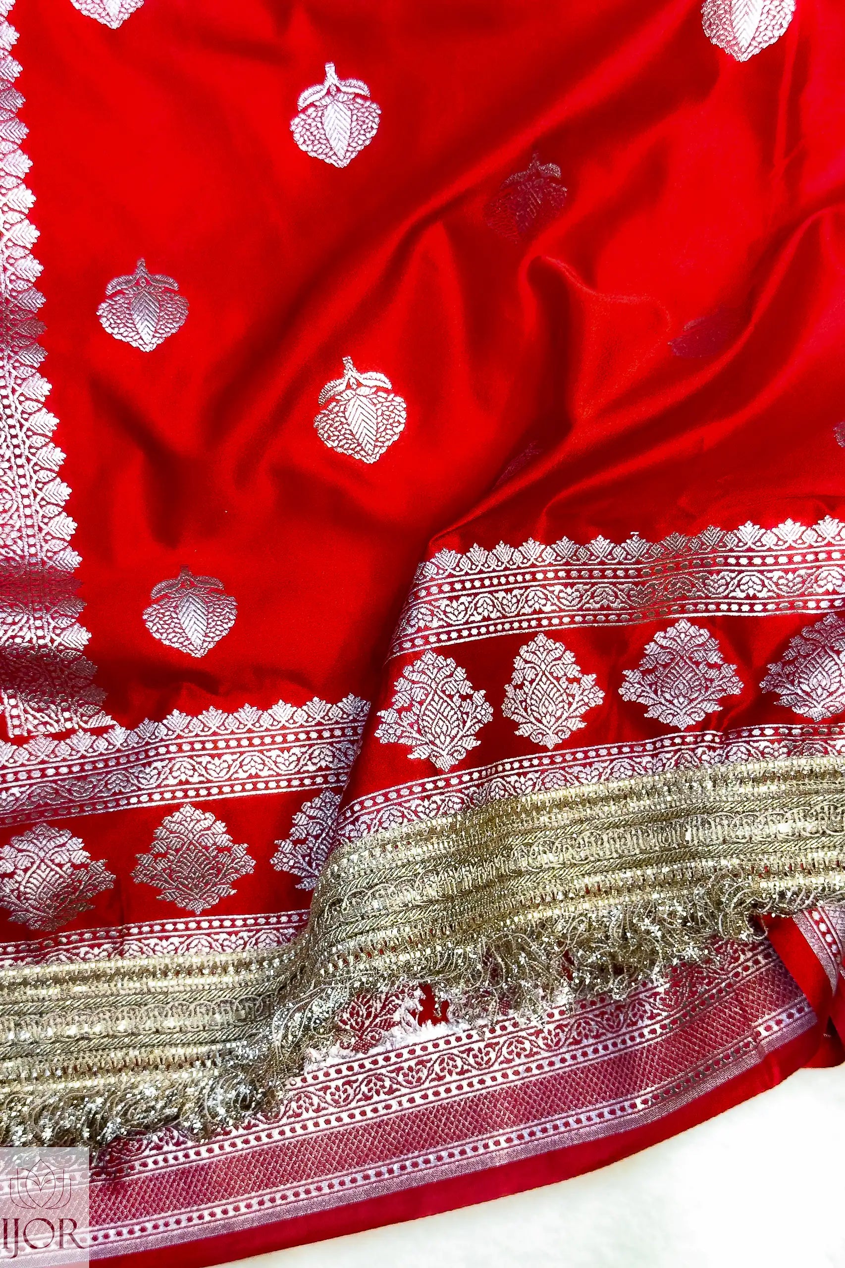 Red Mashru Silk Saree with Maharani Lace with white and gold patterns on a white background