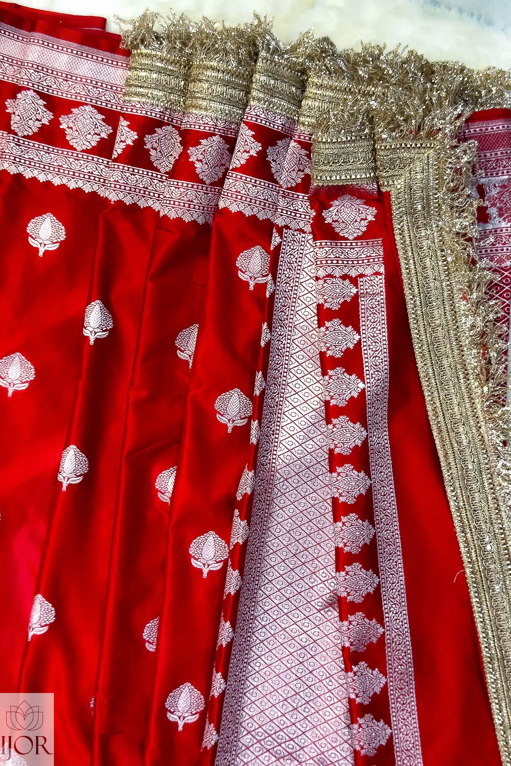 Red Mashru Silk Saree with Maharani Laces and gold accents, featuring the brand 'JOR'.