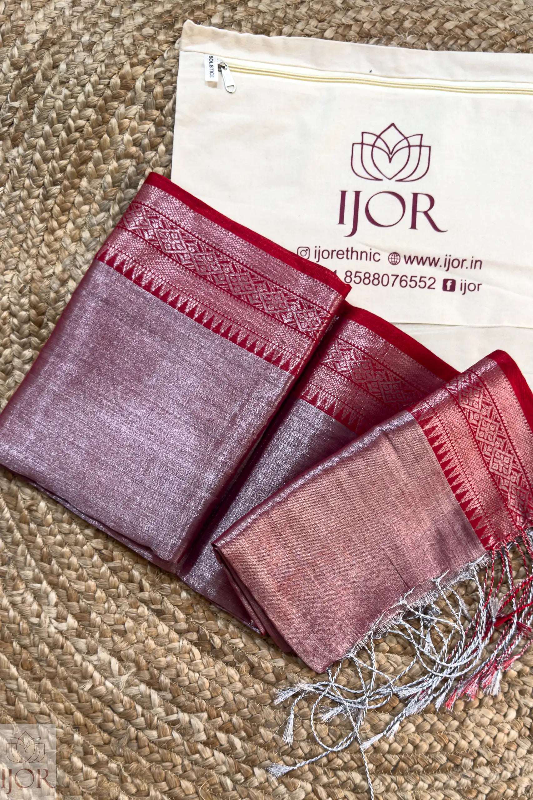 Lavender color Pure Tissue Cotton Saree with intricate patterns on a beige surface, featuring the IJOR brand.