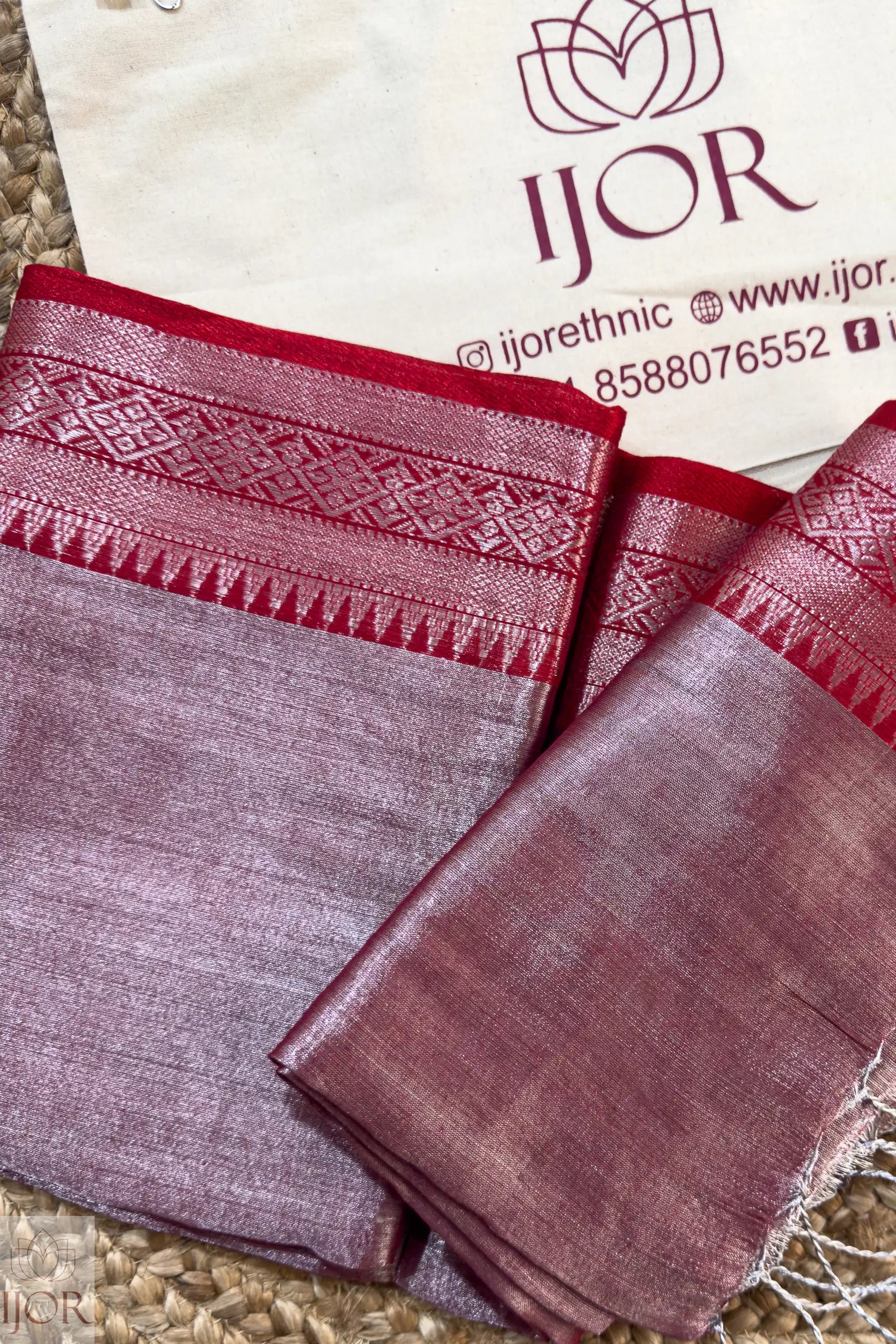 Lavender Color Pure Tissue Cotton Saree with Rich Red Border with intricate patterns on a branded background