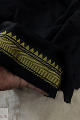 Jharokha Pure Cotton Saree Black and Yellow with temple border held by a hand on a light background