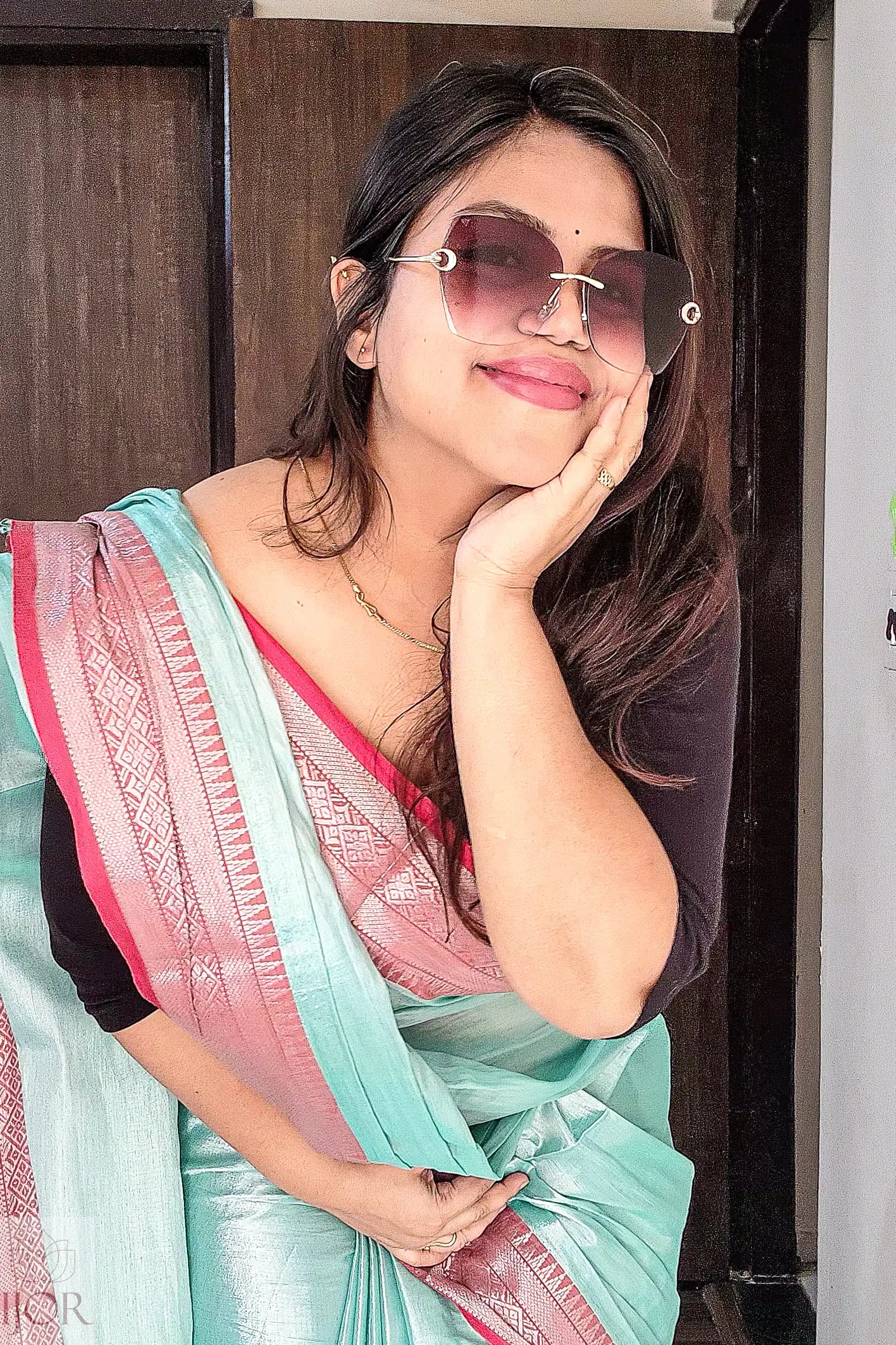 Woman wearing Sea Foam Pure Tissue Cotton Saree with Rich Red Border indoors