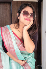 Woman wearing Sea Foam Pure Tissue Cotton Saree with Rich Red Border indoors