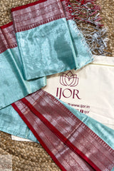 Turquoise Blue Pure Tissue Cotton Saree with Rich Red Border on a brown surface, with IJOR branding visible.