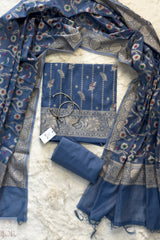 Dusty Blue Muga Silk in Minakari work Unstitched Suit with a tag on a light background