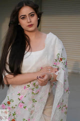 Nav Kaur wearing a Banarasi Soft Organza Silk Saree Ivory with floral patterns in an indoor setting