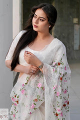 Nav Kaur wearing a Banarasi Soft Organza Silk Saree Ivory with floral patterns, standing against a neutral background.