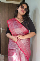 Woman wearing a lavender color saree with a black blouse indoors.