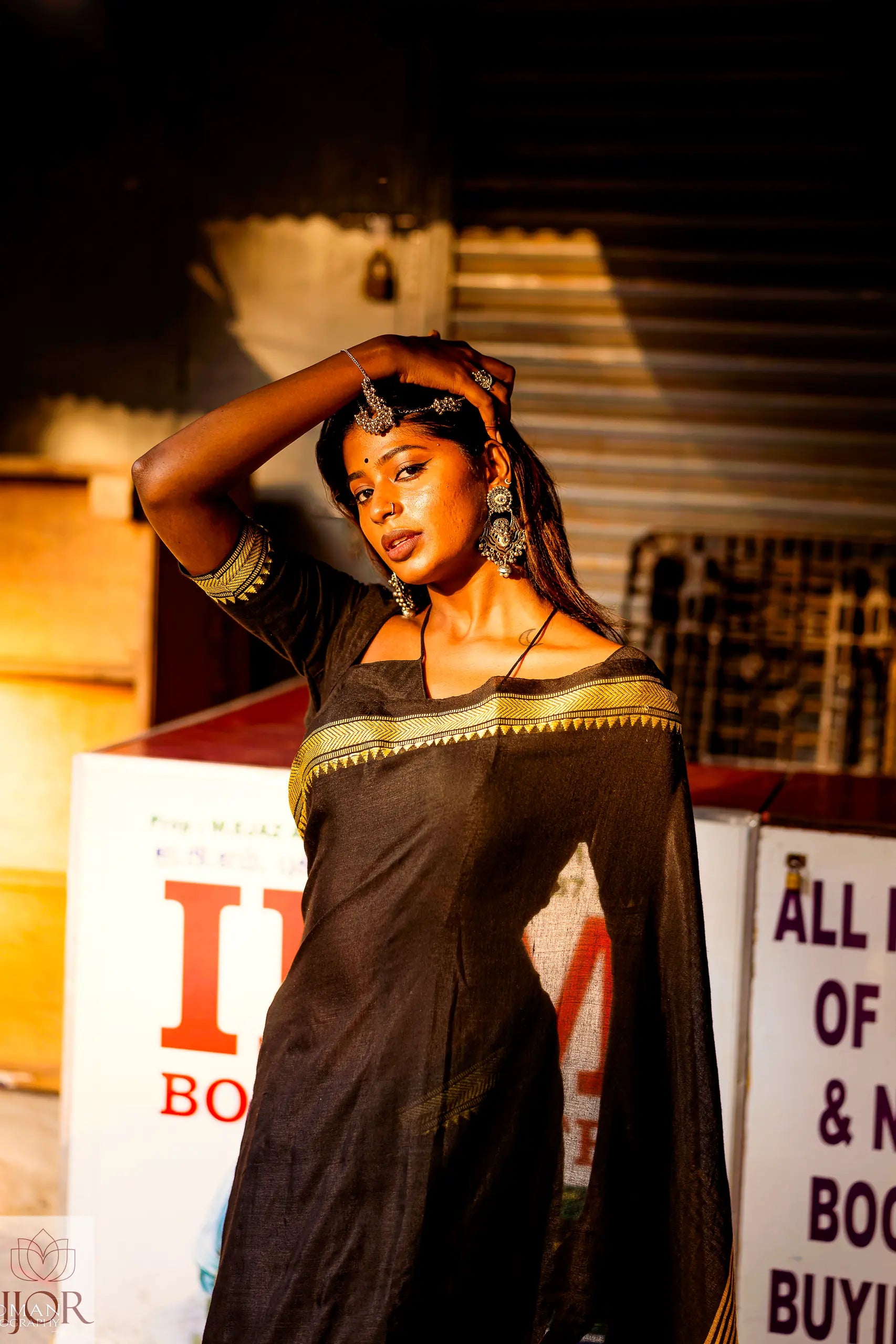 Divya Darshini ft in Jharokha Pure Cotton Saree Black and Yellow  posing in front of a store with visible branding.