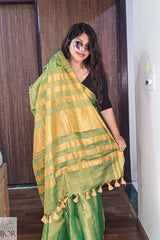   Aarti in Green Golden Zari Pure Tissue Cotton Saree with tassels indoors.
