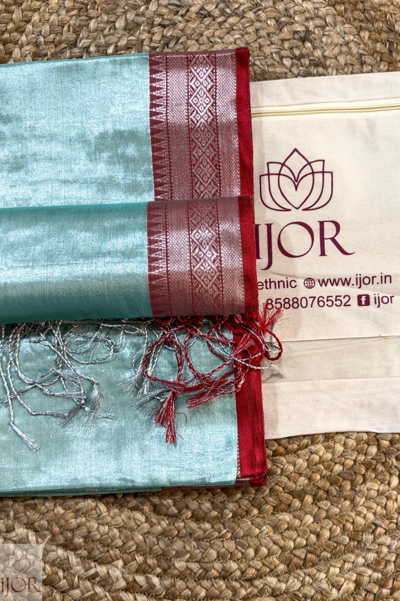 Sea Foam Pure Tissue Cotton Saree with Rich Red Border and 'IJOR' branding on a textured surface